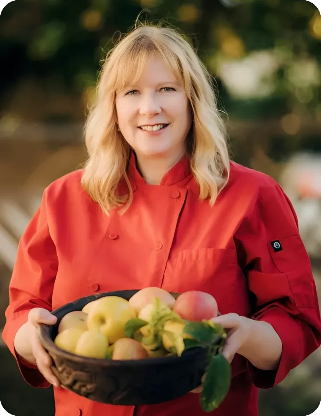 Smiling chef with apples and pears