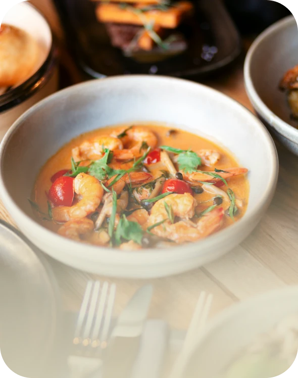 Creamy seafood stew garnished with cilantro.